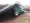 Compost Windrow Turner turning compost covered by a Windrow Cover